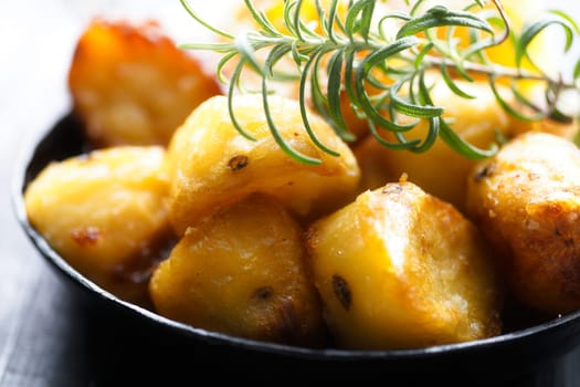 close up of  pan of rustic golden english roasted duck fat potatoes