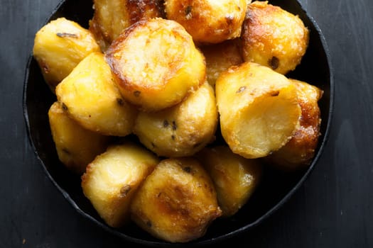 close up of  pan of rustic golden english roasted duck fat potatoes