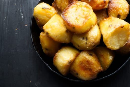 close up of  pan of rustic golden english roasted duck fat potatoes
