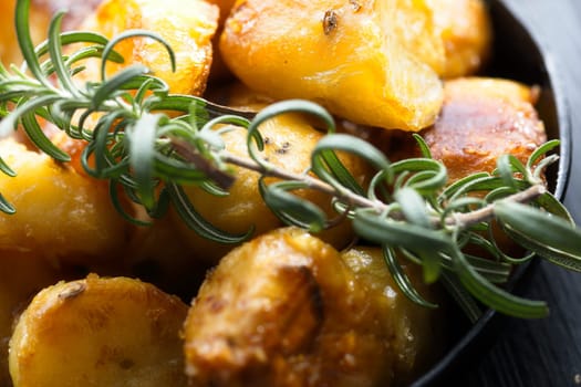 close up of  pan of rustic golden english roasted duck fat potatoes