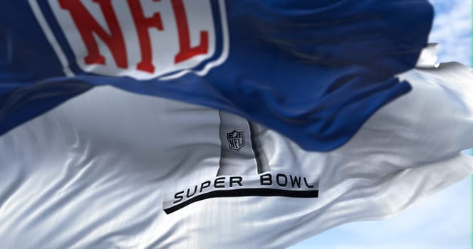 Inglewood, CA, USA, January 2022: The flag with the Super Bowl logo waving in the wind with the NFL flag blurred in the foreground. The game is scheduled to take place on February 13, 2022