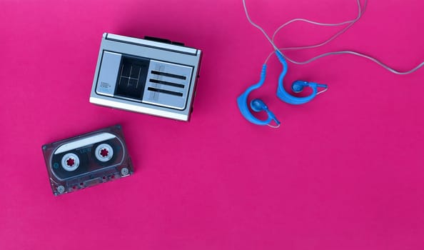 A 90s cassette player, tape and earphones for listening to music on the go
