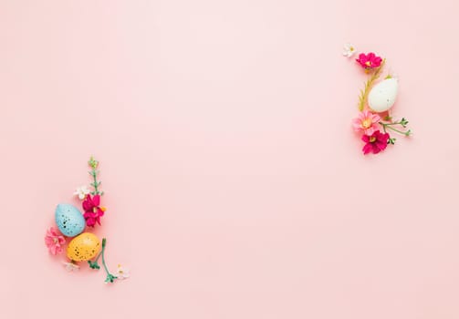 Easter holiday pink mockup background. Top view from above to different colorful Easter eggs, flowers, picture frame border. Card with copy space to place text. Minimal flat lay. High quality photo