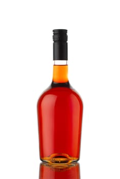 front view closeup of round traditional shape cognac brandy or whisky bottle with no label isolated on white background with reflection