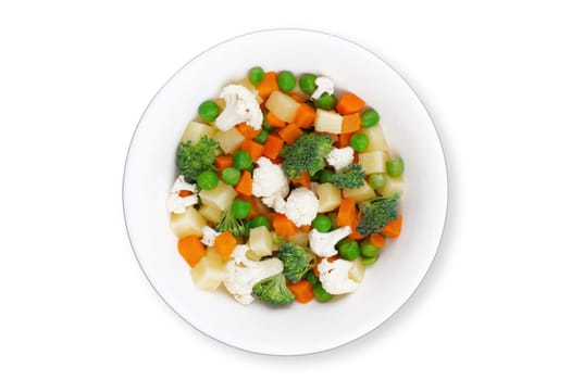 top view closeup of fresh mixed frozen vegetables with carrots peas broccoli and potatoes on round plate isolated on white background