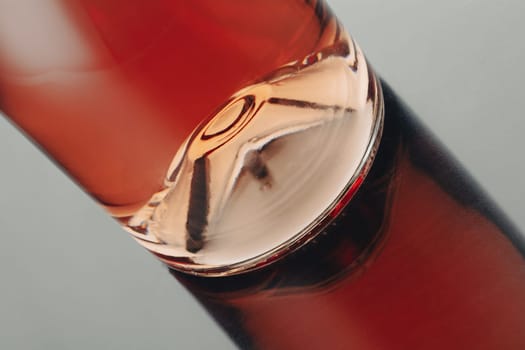 front view closeup of a rose wine bottle punt with reflection on shiny surface