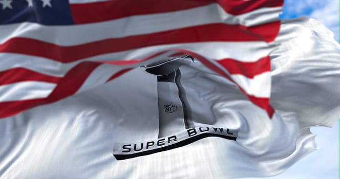 Inglewood, CA, USA, January 2022: The flag of the Super Bowl waving in the wind with the US national flag blurred in the foreground. The Super Bowl is the annual playoff championship game of the NFL