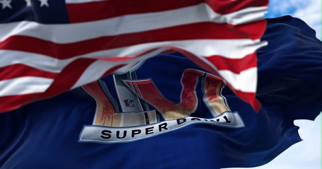 Inglewood, CA, USA, January 2022: The flag of the 56th Super Bowl waving in the wind with the US national flag blurred in the foreground. The game is scheduled to take place on February 13, 2022