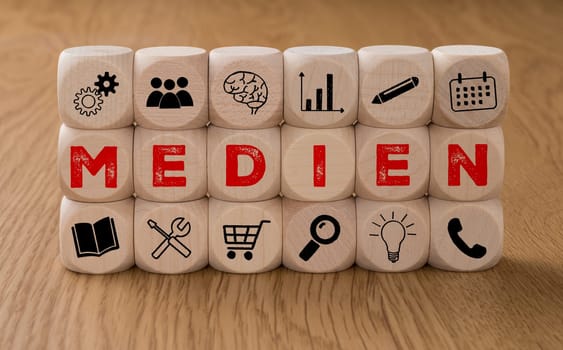Dice with icons and the word Media in german - Medien