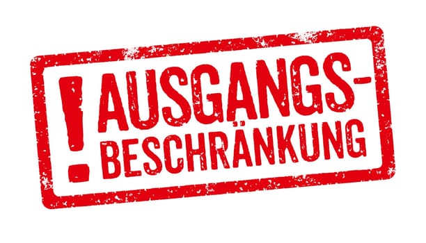 Red stamp on a white background - Curfew in german - Ausgangsbeschränkung