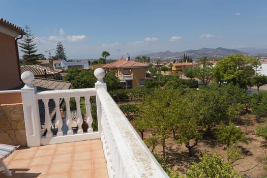 Terraces railing with sea view, blue sky and floral background
