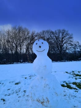 Close up view of snowman in santa hat, scarf and mittens i winter park