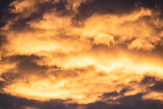Close up view of beautiful colored dramatic cumulus fluffy clouds on blue sky at sunset background