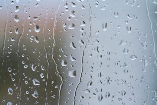 Raindrops on a window pane during rainy weather