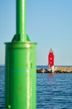green and red lighthouse in the entrance to the port of Krk on the Adriatic Sea in Croatia