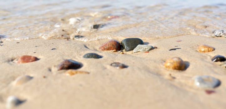 Stones on the beach of Kolobrzeg on the Baltic Sea in Poland in summer