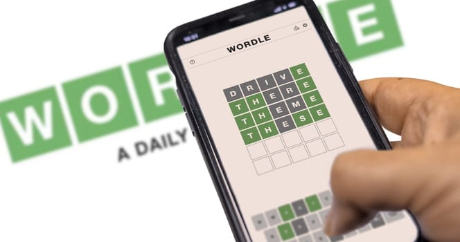 Rome, Italy, January 2022: hand holding a phone with Wordle game running. Wordle is a web-based word game. The game was purchased by The New York Times Company in January 2022