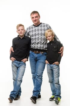 Full length portrait of father and two sons in casual clothes, isolated on white background