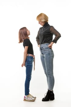 The mother reproachfully looks at the guilty daughter, the daughter looks at the mother with fear, isolated on a white background
