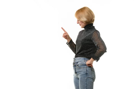 Woman looks to the left and raised her index finger warily, isolated on white background