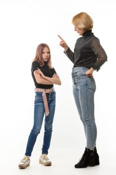 A woman scolds her daughter, an upset daughter looks into the frame