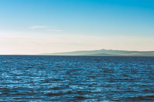Beautiful coast, blue sea and mountains in the distance. Nice view of the blue Adriatic sea during a sunny day.