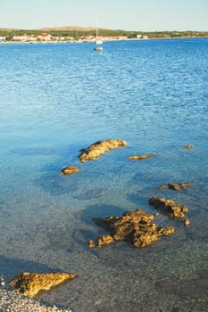 Beautiful coast, blue sea and mountains in the distance. Nice view of the blue Adriatic sea during a sunny day.