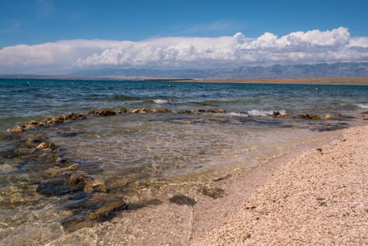 Beautiful coast, blue sea and mountains in the distance. Nice view of the blue Adriatic sea during a sunny day.