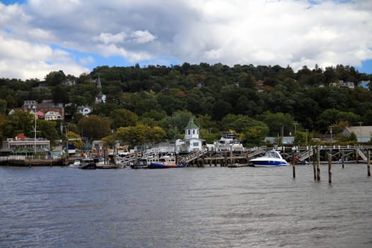 The boats and the houses on the Hudson river in the village of Tarrytown in New York State