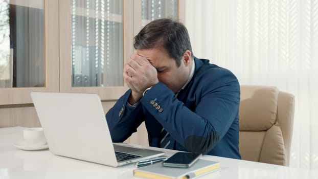 Stressed businessman feeling sick and tired while sitting at his working place, Angry and frustrated strain, businessman overworked upset with laptop unhappy and fail his work