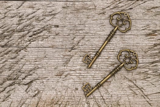 golden vintage key on a grungy wooden background