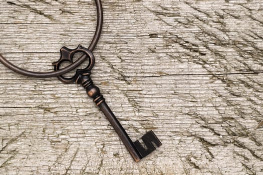 vintage key with ring on a grungy wooden background