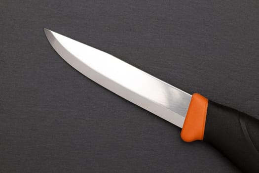 close up of camping knife on a black background