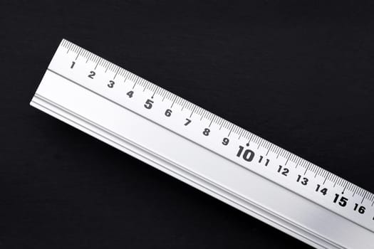 close up of steel ruler on black background
