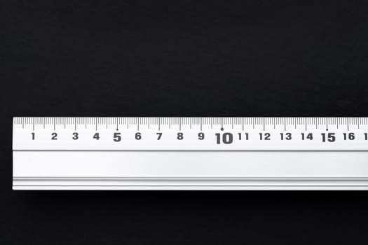 close up of steel ruler on black background