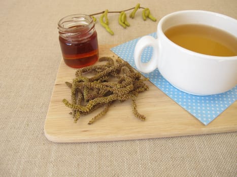 Herbal tea with hazel catkins, hazel flowers from hazel bush