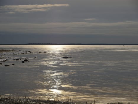 dark cloudscape dramatic seascape, water covered with ice