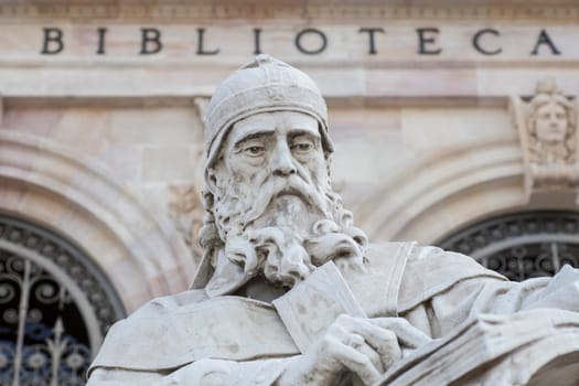 Madrid, Spain - March 6th, 2021: Isidore of Seville statue at National Library of Spain, Madrid. Medieval Spanish scholar