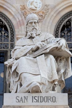 Madrid, Spain - March 6th, 2021: Isidore of Seville statue at National Library of Spain, Madrid. Medieval Spanish scholar