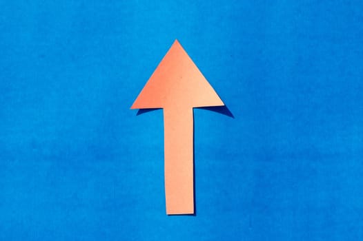 A up facing arrow symbol indicating upward direction. Isolated on blue background. Useful for signage and for way finding and surface markings.