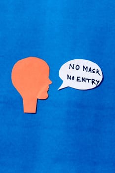 Paper Human face with No Mask No Entry sign on speech bubble isolated on blue background. Conceptual images showing that a person must accepts the conditions of wearing a mask before entering.