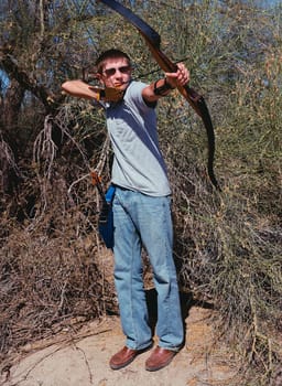 Young archer shooting a traditional long bow