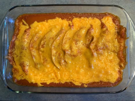 Chicken enchiladas in red chile sauce preparation