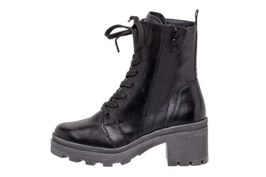 Womens boots and shoes. Closeup of female elegant black leather winter boots. Latest trends of winter shoe fashion for girls isolated on white background. Macro.