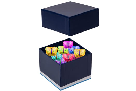 Gift box isolated. Close-up of a blue opened present or gift box with colourful sweets on a white background. Birthday, Valentine's Day, anniversary or other holiday. Macro.