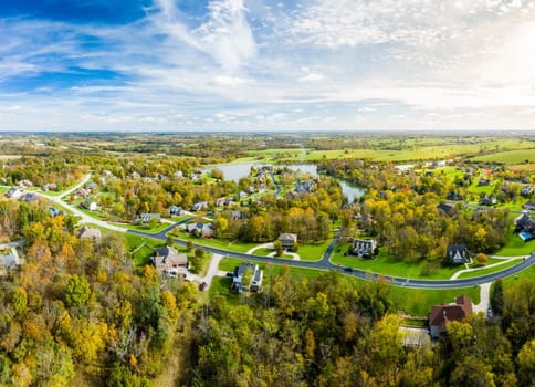 Aerial footage of residential subdivision by a lake in Central Kentucky in fall