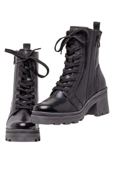 Womens boots and shoes. Closeup of a pair female elegant black leather winter boots. Winter shoe fashion for girls isolated. Clipping path. Macro.