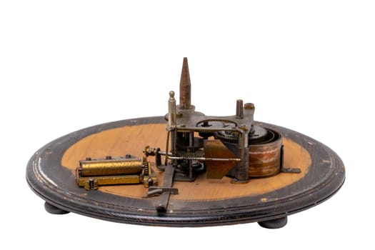 Inside the antique revolving Christmas tree stand the mechanism for playing two Christmas carols consisting of roller mechanism with music box and spring drive. Clipping path.