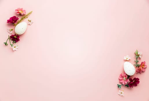 Easter holiday pink mockup background. Top view from above to white Easter eggs, different colorful flowers, frame border. Card with copy space to place text. Minimal flat lay. High quality photo