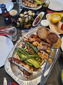 Beef steak with grilled vegetables and seasoning on serving board